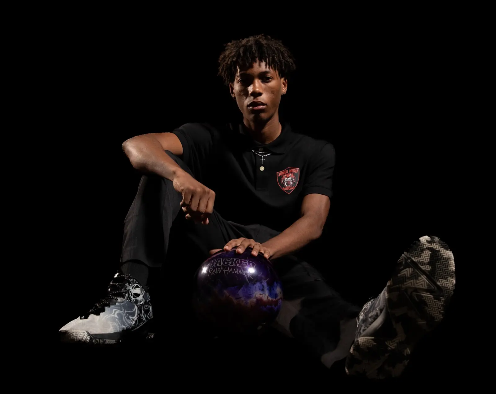 Jones High bowling athlete posing with a bowling ball during Media Day
