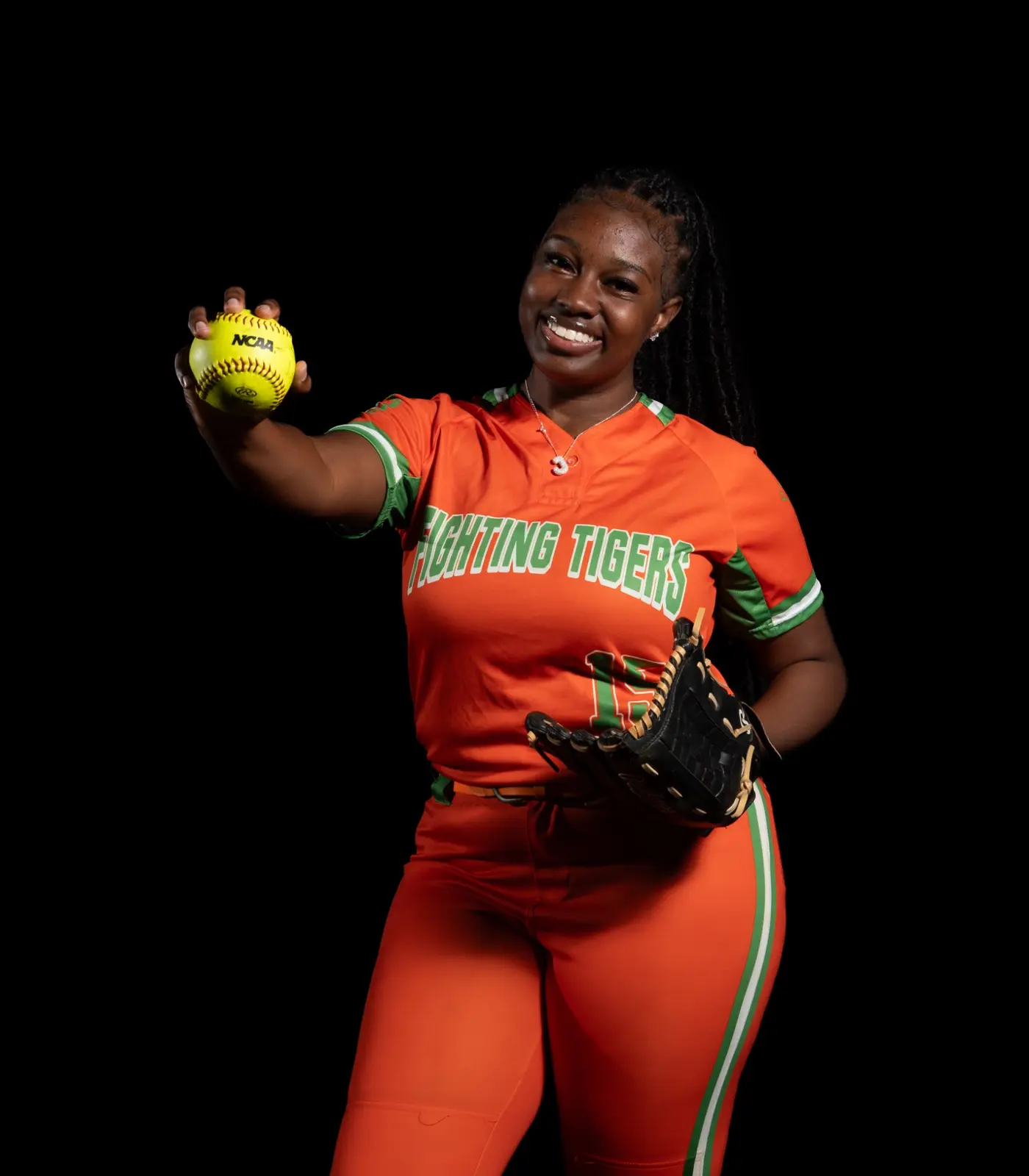 Jones High softball athlete holding a softball and glove during Media Day